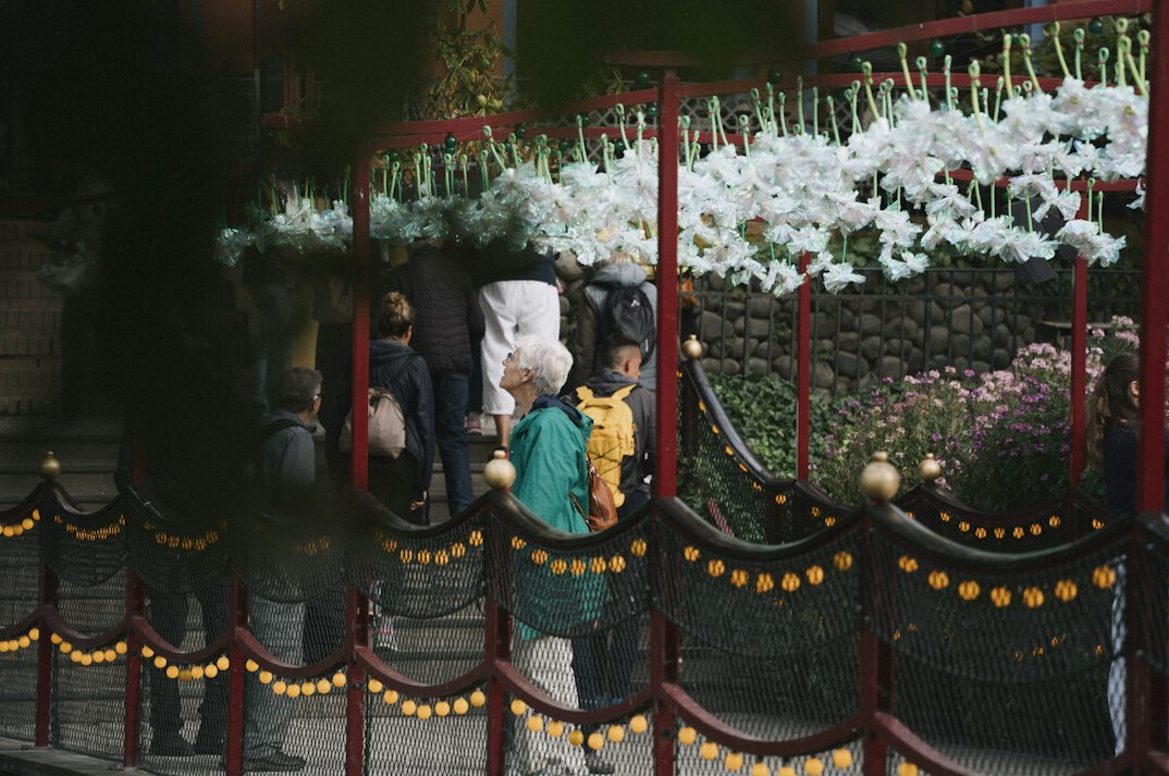 Families queuing at the entrance gate of a historic amusement park in Copenhagen